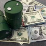 WAR PROFITS Trigger Trump Fury Two green oil barrels placed on a pile of hundred dollar bills