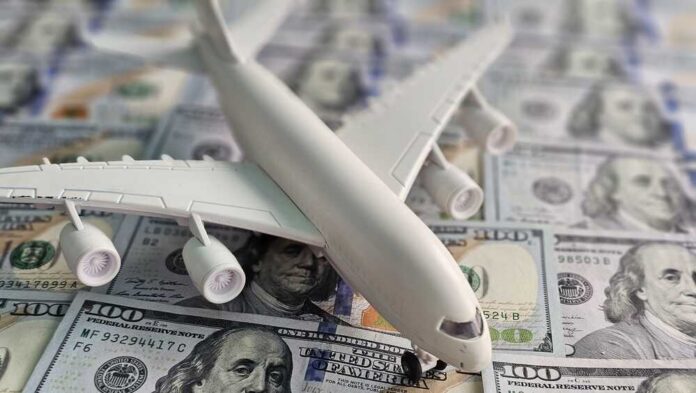 Model,Airplane,Placed,On,A,Pile,Of,Hundred,Dollar,Bills