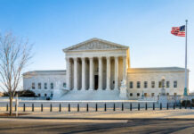 Supreme Court building with columns and U.S. flag