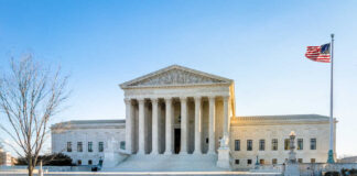 Supreme Court building with columns and U.S. flag