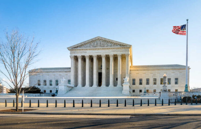 Supreme Court building with columns and U.S. flag