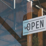 Hanging open sign on a storefront window