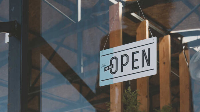 Cu,We,Are,Open,Sign,Hanging,On,The,Entrance,Door Hanging open sign on a storefront window