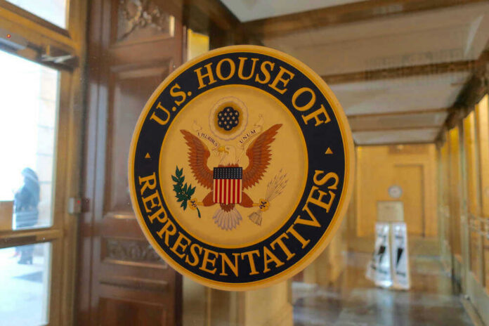 U.S. House of Representatives seal on glass door.