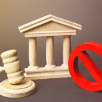 Wooden courthouse with a gavel and red prohibition symbol