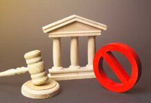 Wooden courthouse with a gavel and red prohibition symbol