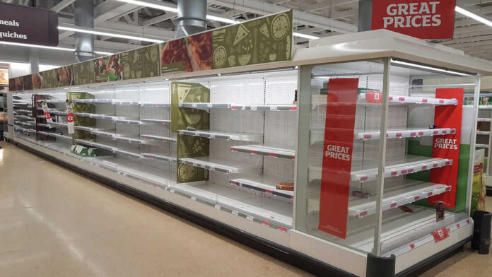 Empty supermarket shelves with great prices signage