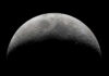 Pentagon Expands Battlefield To The Moon? Half moon in a black sky with visible craters.