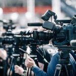 Supreme Court: Rights Violated, No Payout Broadcast cameras on tripods at a press event