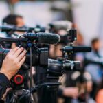 Retirement Bombshell: Social Security Cuts Loom Sooner Video cameras on tripods at a media event