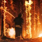 VIDEO: Firestorm Kills Three — What Went Wrong? Firefighter battling a raging forest wildfire at night
