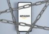 Pay Shock: Amazon Sets New Standard? Smartphone with e-commerce logo wrapped in metal chains