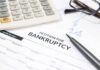 Bankruptcy Swallows Another Breakfast Favorite Bankruptcy petition form with pen, calculator, and eyeglasses