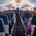 VIDEO: Terrifying Drop Mid-Flight – Horrifying Details Airplane interior with passengers seated mid-flight.