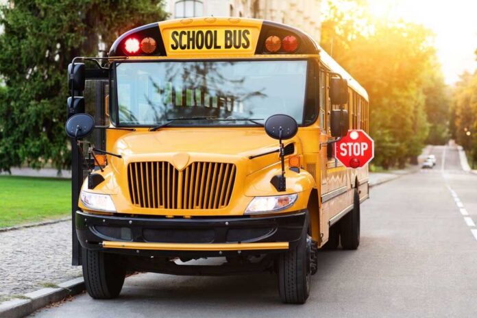 Old-fashioned,Yellow,School,Bus,With,Red,Stop,Sign,On,The