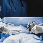 Surgeons performing a procedure in an operating room