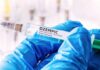 Gloved hands holding a syringe labeled Ozempic