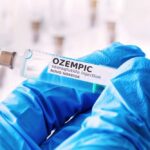 Gloved hands holding a syringe labeled Ozempic