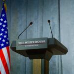 Senate Shock: U.S. Senator Dies After Kyiv Trip Press podium with the White House sign and an American flag in the background