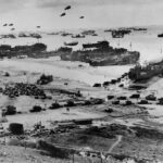 Allied landing on Normandy beach during D-Day, WWII.
