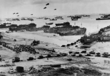 Allied landing on Normandy beach during D-Day, WWII.