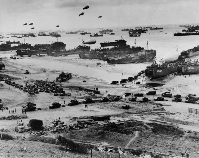 shutterstock_249573949-1 Allied landing on Normandy beach during D-Day, WWII.