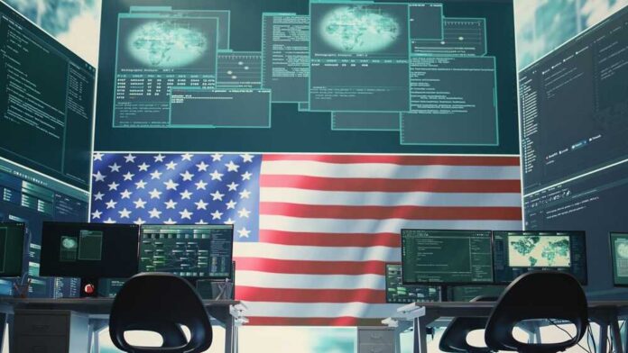 A high-tech workspace featuring multiple computer monitors displaying data and an American flag in the background