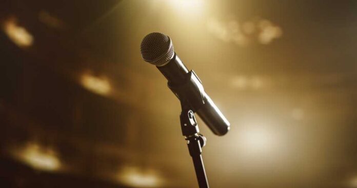 Close-up of a microphone on a stage with soft lighting