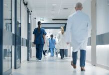Medical staff walking through a hospital corridor