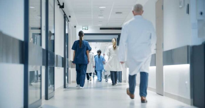 Medical staff walking through a hospital corridor