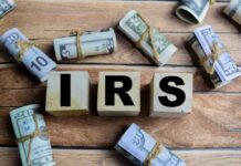Bombshell Report: IRS Cash Pipeline Craters Wooden blocks spelling IRS surrounded by rolled currency notes