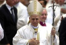 Catholic bishop in white vestments holding a crosier