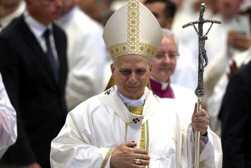 Catholic bishop in white vestments holding a crosier