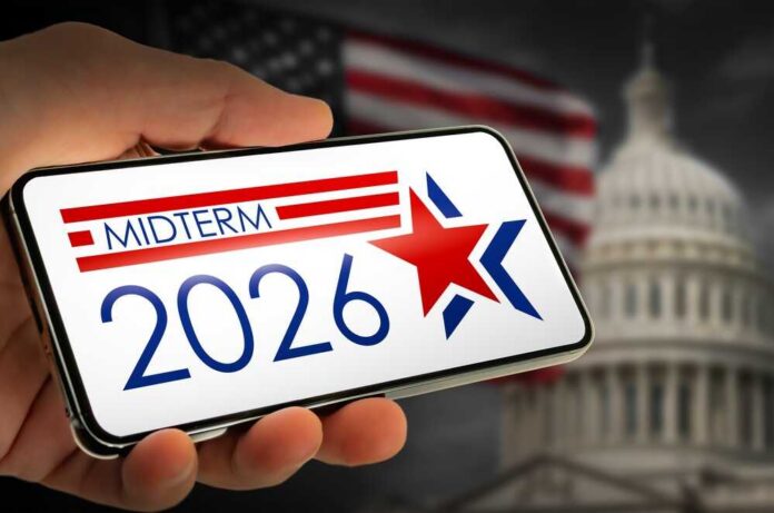 Hand holding a smartphone displaying 'MIDTERM 2026' with a star and American flag in the background