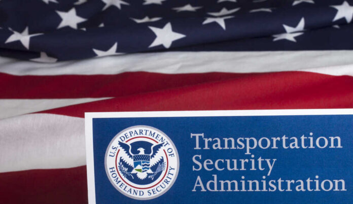Transportation,Security,Administration,Form,To,Fill,Out Transportation Security Administration sign in front of an American flag