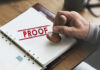 PROOF: Pay Hike Backfires – Orders Vanish A hand holding a wooden stamp over a document marked 'PROOF'