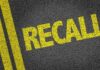 RECALL: Pickup Truck Fire Risk Exposed Yellow 'RECALL' text on a dark asphalt surface