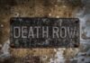 Weathered metal sign reading 'DEATH ROW' on a wall