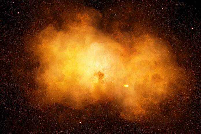 shutterstock_660903751 Bright orange cosmic explosion in space with stars around.