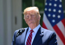 Donald Trump at a podium with a U.S. flag in the background