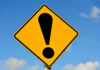 Trusted Coach EXPOSED Yellow caution sign with exclamation mark symbol.