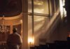 BOMBSHELL: Archbishop vs. Pentagon A clergy member standing in a church with light streaming through windows