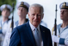 Biden Prosecutor Under FBI Heat Joe Biden stands in front of uniformed honor guards