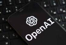 Smartphone displaying OpenAI logo on a keyboard