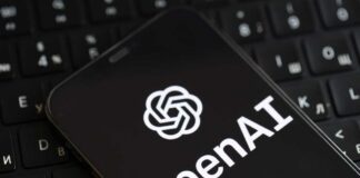 Smartphone displaying OpenAI logo on a keyboard