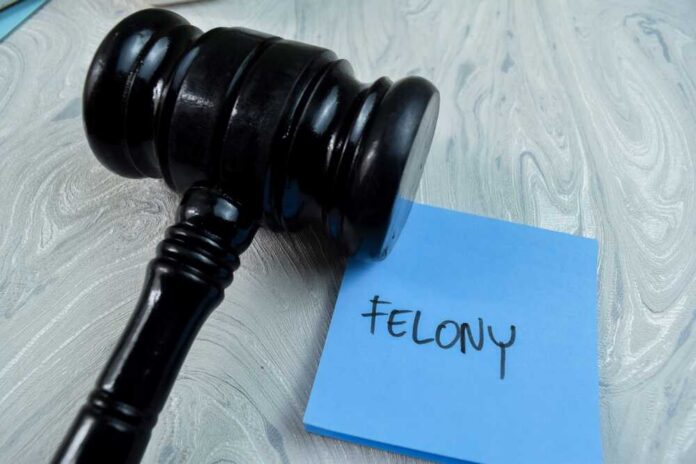 Judge's gavel resting on a blue sticky note