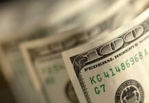 Trump Dangles $50B – Why? Close-up of a stack of hundred dollar bills