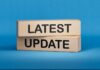 Government Paper Trails a Trippy Program Wooden blocks with the words latest update on blue background