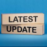 Wooden blocks with the words latest update on blue background