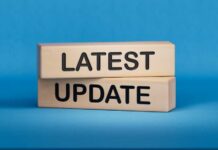 Wooden blocks with the words latest update on blue background